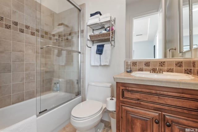 full bathroom featuring tasteful backsplash, vanity, enclosed tub / shower combo, and toilet