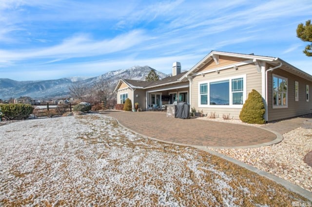 back of property featuring a mountain view