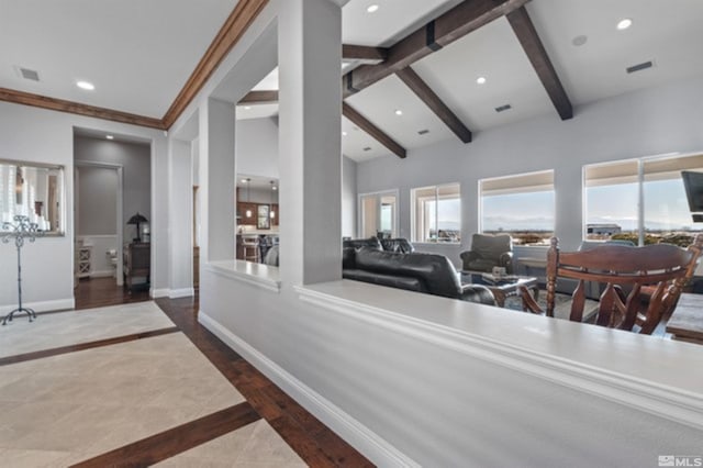 interior space with beam ceiling and high vaulted ceiling