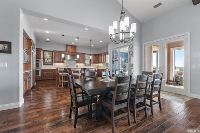 dining space with dark wood-type flooring, a chandelier, and french doors