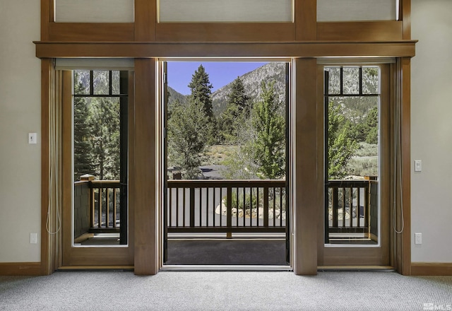 entryway featuring a healthy amount of sunlight and carpet flooring