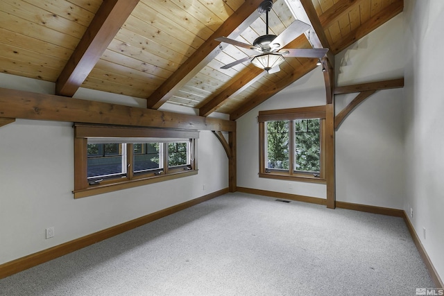 bonus room with ceiling fan, plenty of natural light, carpet flooring, and vaulted ceiling with beams