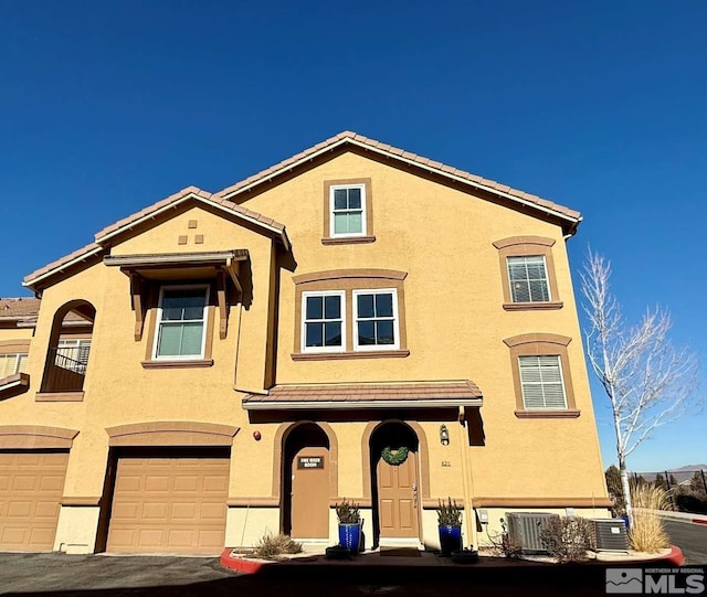 view of front of house with cooling unit and a garage