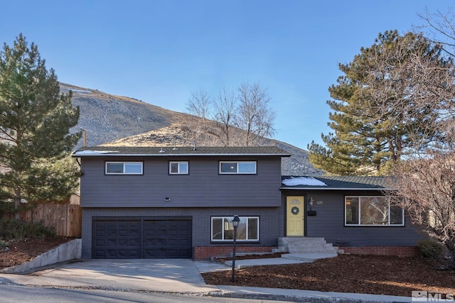 view of front of home with a mountain view and a garage