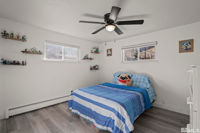 bedroom featuring ceiling fan, wood-type flooring, and a baseboard heating unit