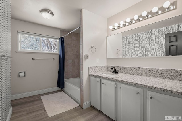 bathroom featuring vanity, hardwood / wood-style flooring, and shower / bath combination with curtain