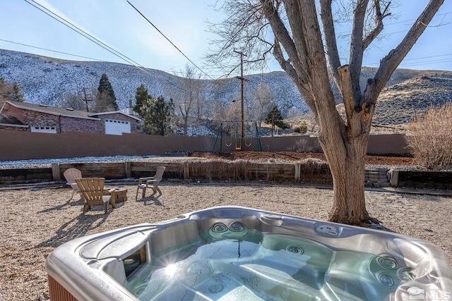 exterior space featuring a hot tub and a mountain view