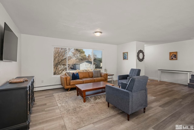 living room featuring a baseboard radiator and wood-type flooring