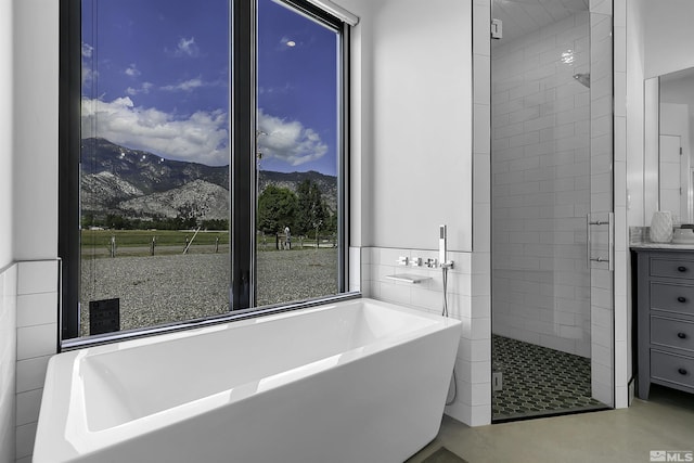 bathroom with a mountain view and separate shower and tub