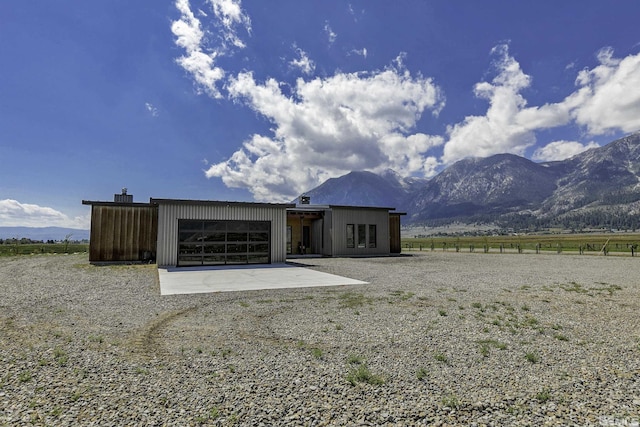 rear view of property featuring a rural view and a mountain view