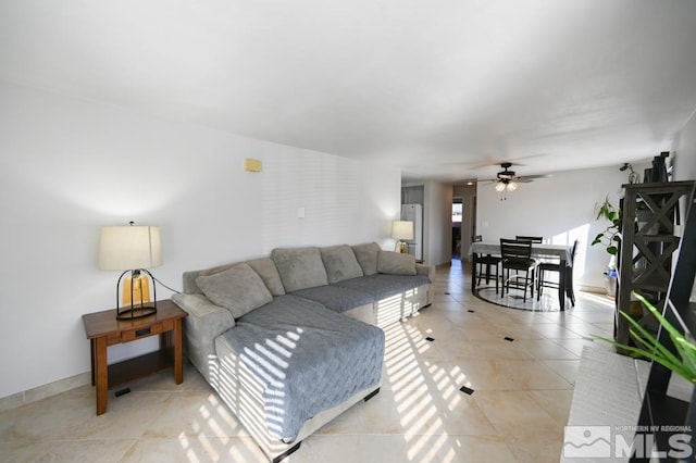 living room featuring ceiling fan and light tile patterned flooring