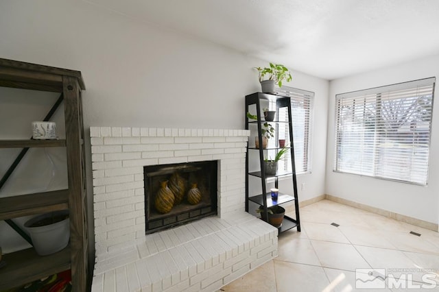 tiled living room featuring a fireplace