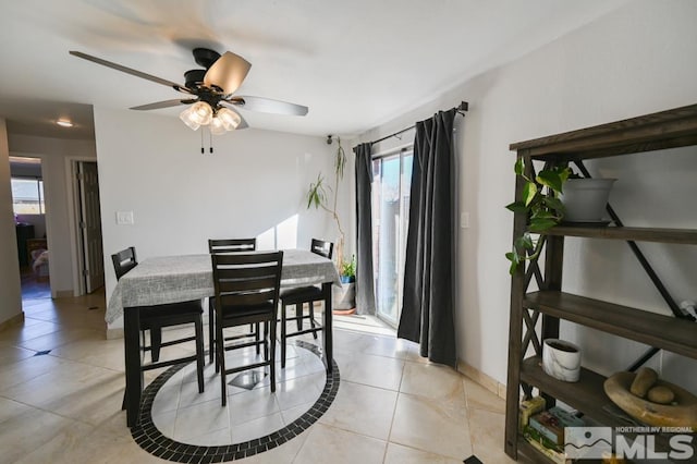 dining room featuring light tile patterned floors and ceiling fan