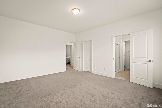 unfurnished bedroom with light carpet