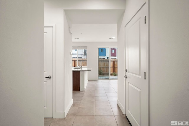 hall with light tile patterned flooring