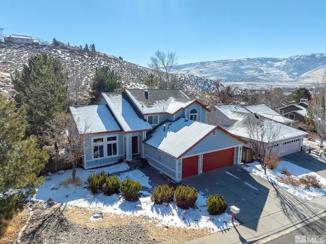 snowy aerial view featuring a mountain view