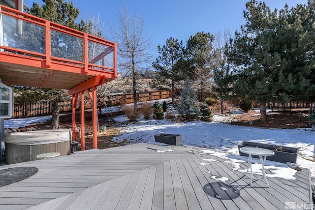 snow covered deck featuring central AC unit and a hot tub