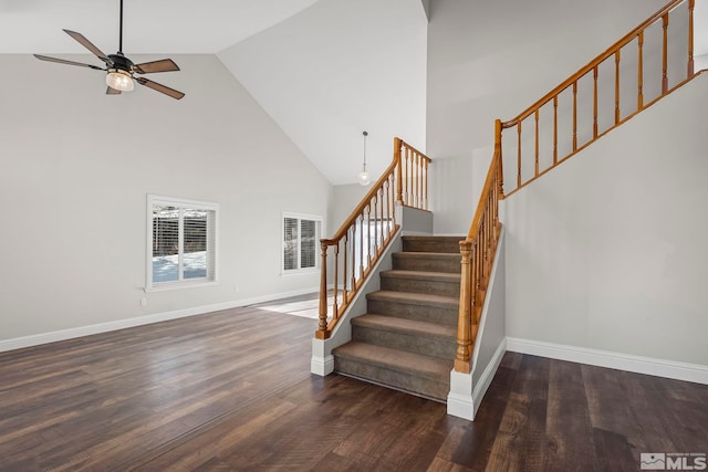 stairway featuring high vaulted ceiling, hardwood / wood-style floors, and ceiling fan