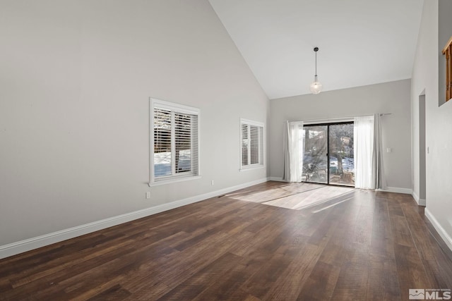 unfurnished room featuring dark hardwood / wood-style floors and high vaulted ceiling