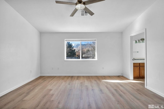 spare room with ceiling fan and light hardwood / wood-style floors