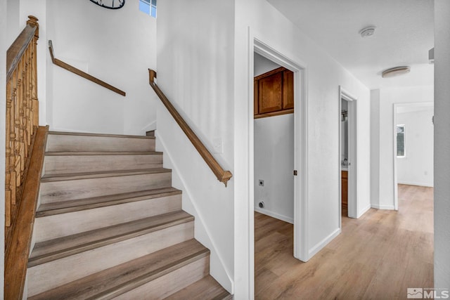 stairway with hardwood / wood-style flooring