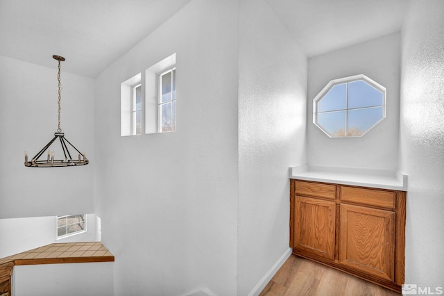 hallway with a healthy amount of sunlight and light wood-type flooring