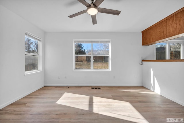 empty room featuring ceiling fan and light hardwood / wood-style floors