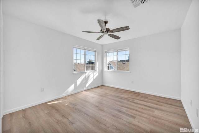 empty room with ceiling fan and light wood-type flooring