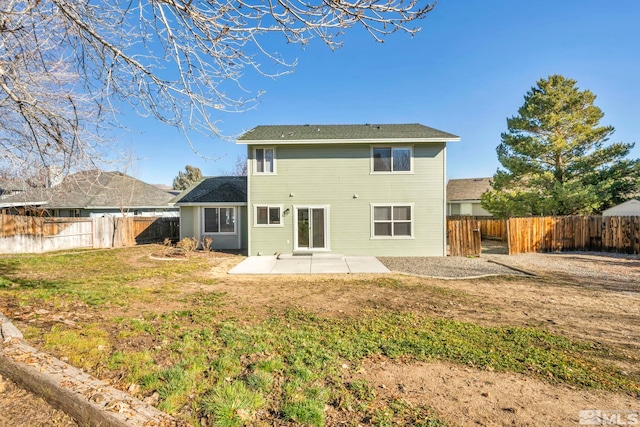 back of property with a patio and a lawn