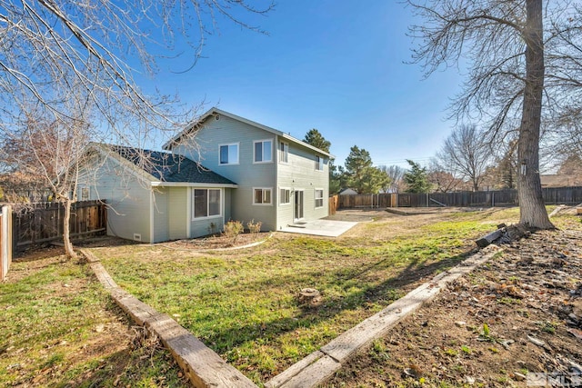 back of property featuring a lawn and a patio area