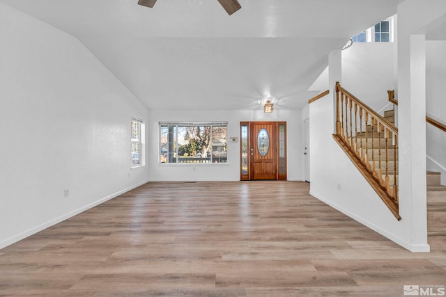 entrance foyer featuring vaulted ceiling, ceiling fan, and light wood-type flooring