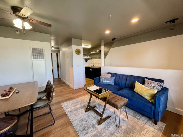 living room with a ceiling fan, light wood-type flooring, baseboards, and recessed lighting