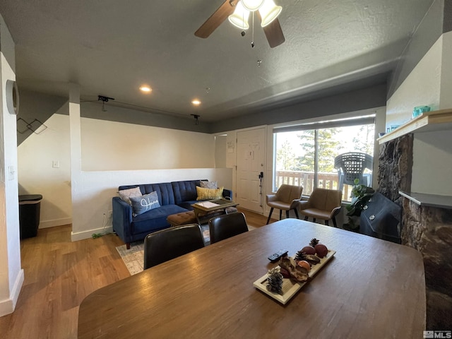 dining room with a textured ceiling, recessed lighting, a ceiling fan, baseboards, and light wood-type flooring