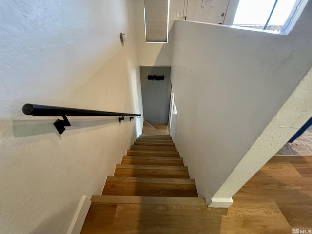 stairs with wood finished floors