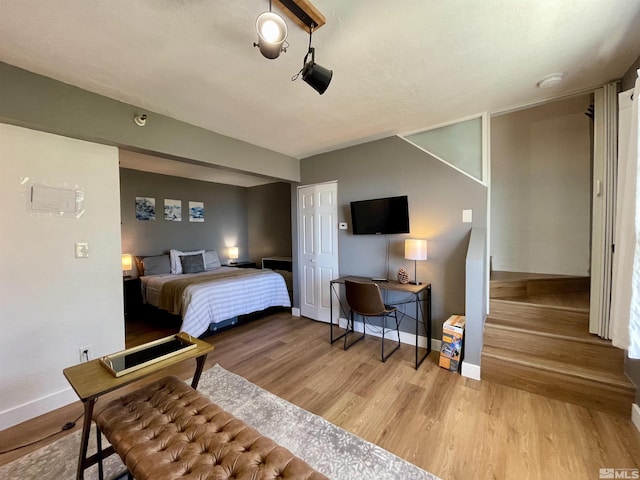 bedroom featuring wood finished floors and baseboards