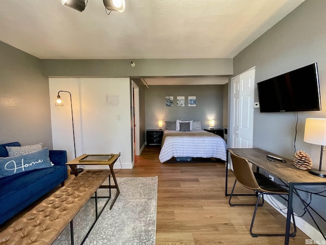 bedroom with baseboards and wood finished floors