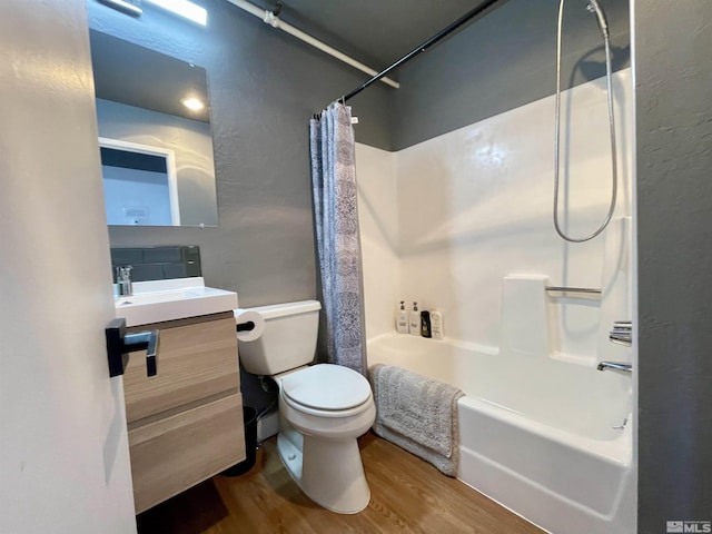 bathroom featuring shower / bath combo, vanity, toilet, and wood finished floors