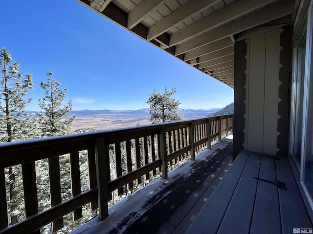 wooden deck with a mountain view