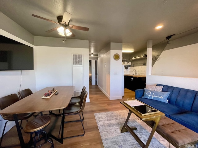 living area with ceiling fan, recessed lighting, visible vents, baseboards, and light wood-style floors