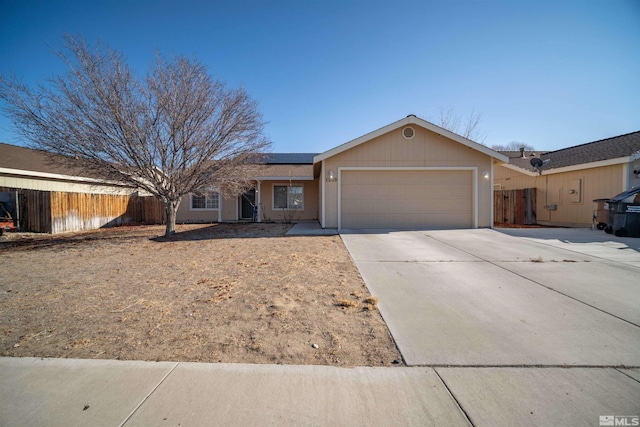 ranch-style house with a garage and solar panels