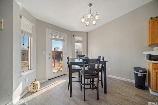 dining room featuring an inviting chandelier and light hardwood / wood-style floors