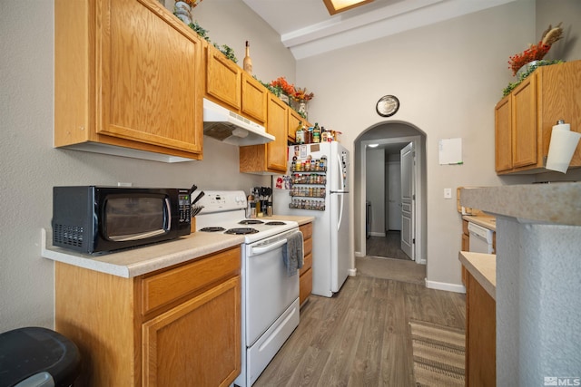 kitchen with white appliances and hardwood / wood-style floors