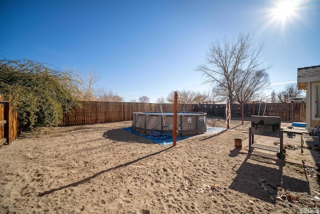 view of yard with a fenced in pool