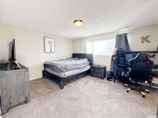 carpeted bedroom with a textured ceiling