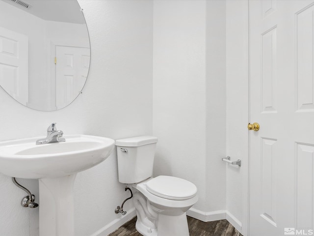 bathroom with sink, hardwood / wood-style flooring, and toilet