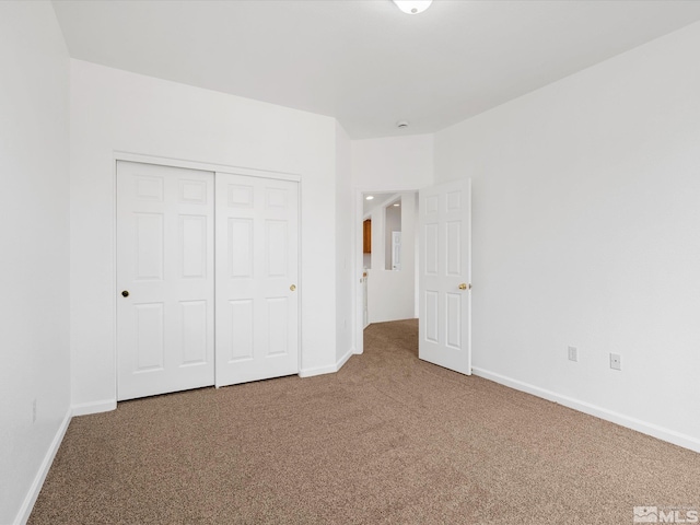 unfurnished bedroom with carpet and a closet