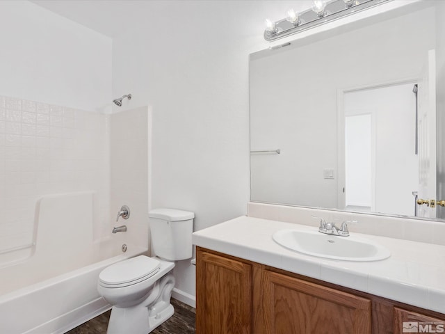 full bathroom featuring  shower combination, toilet, hardwood / wood-style floors, and vanity