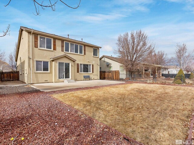 rear view of property featuring a lawn and a patio area