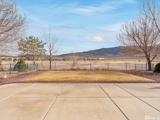 view of yard featuring a mountain view and a patio