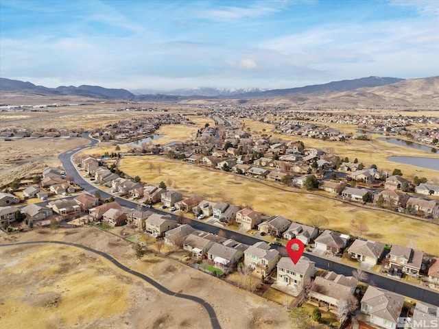 drone / aerial view with a water and mountain view